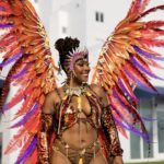 Tracey standing in carnival costume with large wings