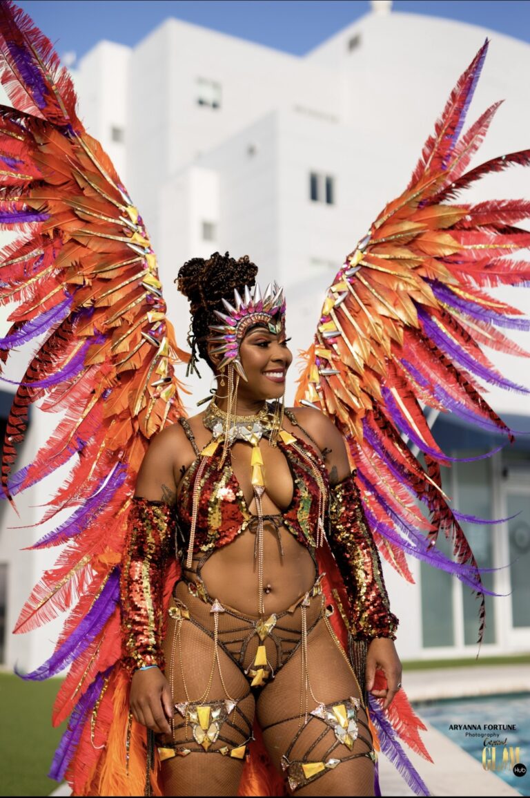 Tracey standing in carnival costume with large wings